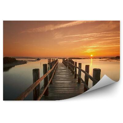 Fototapeta Dřevěné molo nad vodou při západu slunce
