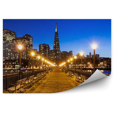 Samolepící fototapeta Staré molo krajina domy jezero obloha mraky