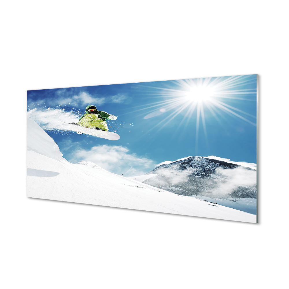 Obraz ze skla Snowboardista na pozadí hor a slunce